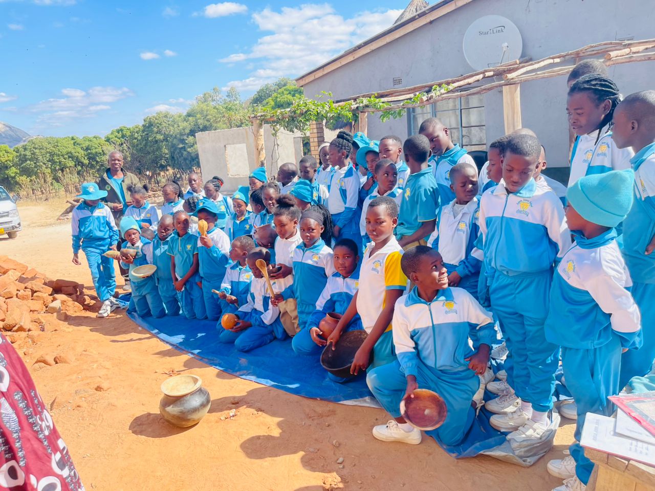 Jewels Junior School learners with clay pots and wooden spoons