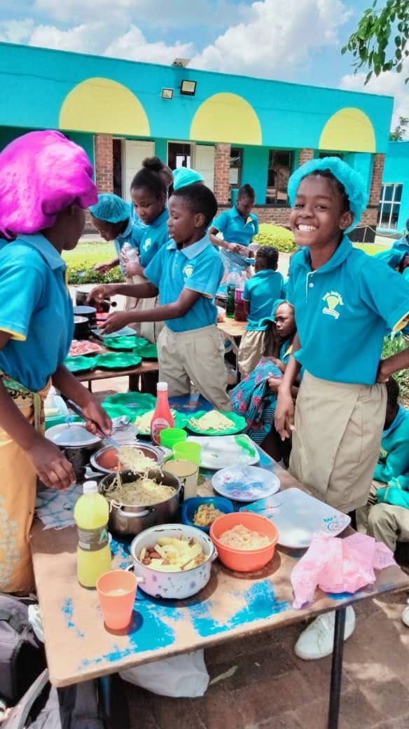 Jewels Junior School learners cooking and serving food together