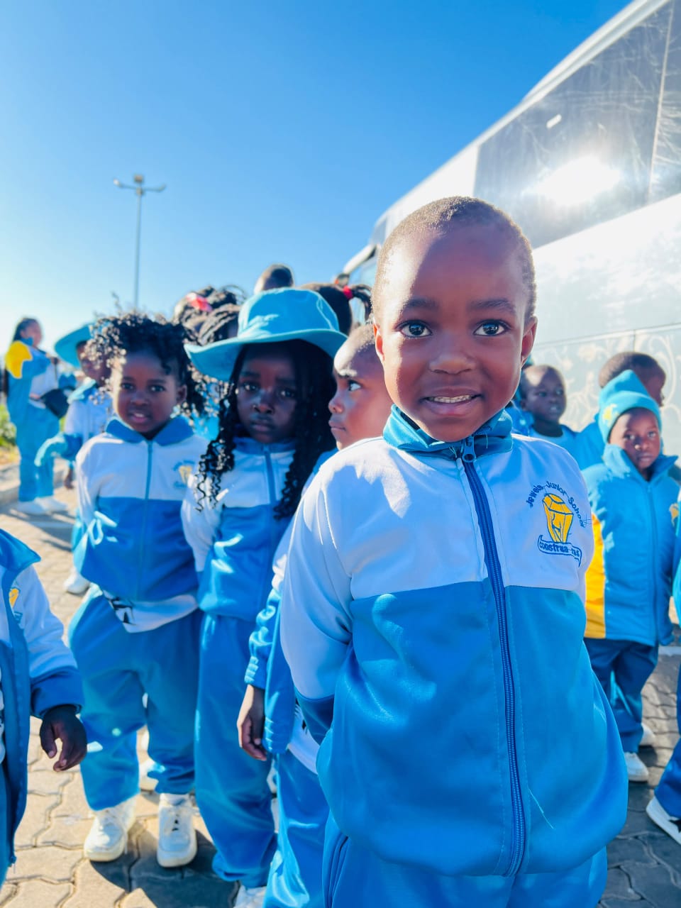 Jewels Junior School learners waiting to board the bus